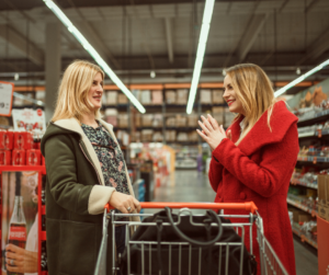 two women talking in grocery store